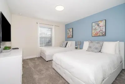 a bedroom with a large white bed and a couch at 4 BD 3 BA Private Pool Storey Lake 4832 in Kissimmee
