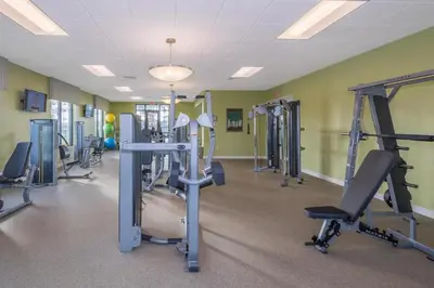 a gym with several tread machines in a room at 4 BD 3 BA Private Pool Storey Lake 4832 in Kissimmee