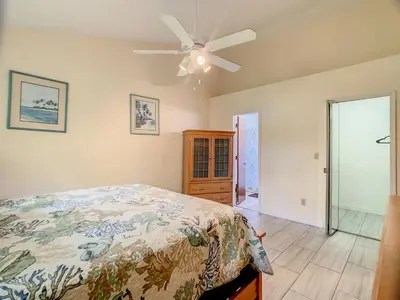 a bedroom with a bed and a ceiling fan at Quaint Getaway! 3 Bedroom Condo Near Disney Parks! in Kissimmee