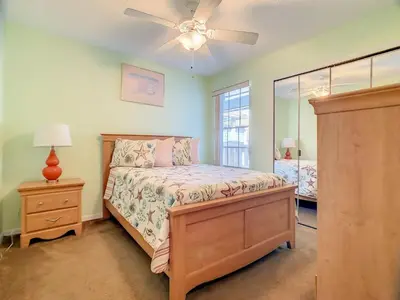 a bedroom with a bed and a ceiling fan at Quaint Getaway! 3 Bedroom Condo Near Disney Parks! in Kissimmee