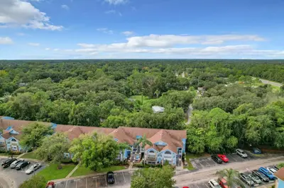an overhead view of a house with a parking lot at Quaint Getaway! 3 Bedroom Condo Near Disney Parks! in Kissimmee