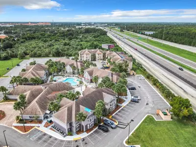 an aerial view of a residential neighborhood with a highway at Be Our Guest! 1 Bedroom Condo Near Disney Parks! in Orlando