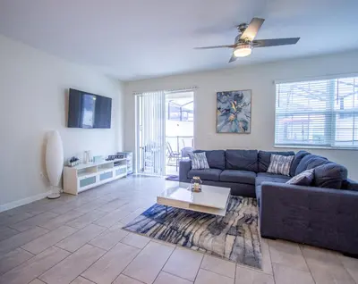 a living room with a couch and a table at Enchanted Orlando Getaway, 10 minutes from Disney in Kissimmee