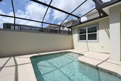 a swimming pool in the backyard of a house at Enchanted Orlando Getaway, 10 minutes from Disney in Kissimmee