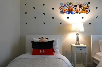 a bedroom with a bed with aesame street decal on the wall at Enchanted Orlando Getaway, 10 minutes from Disney in Kissimmee