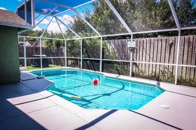 a swimming pool with a ball in the middle at Heated pool house with mini golf 10 min to Disney in Orlando