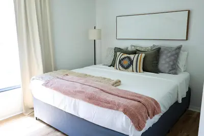 a bedroom with a large bed with a blanket on it at Heated pool house with mini golf 10 min to Disney in Orlando