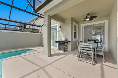 a home with a pool and a ceiling fan at Disney Getaway Prime Location Themed Rooms in Kissimmee