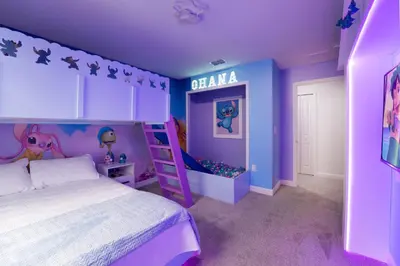 a purple bedroom with a bed and a purple wall at Disney Getaway Prime Location Themed Rooms in Kissimmee