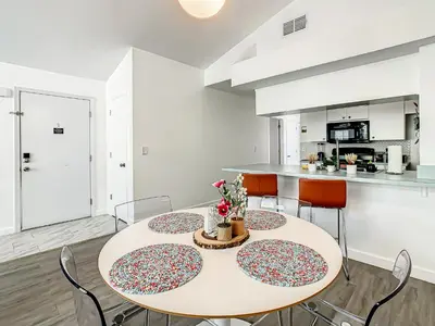 a kitchen and dining room with a table and chairs at La Casa Mediterranean! 3 Bedroom Condo Near Disney! in Kissimmee