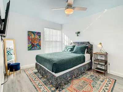 a bedroom with a bed and a painting on the wall at La Casa Mediterranean! 3 Bedroom Condo Near Disney! in Kissimmee