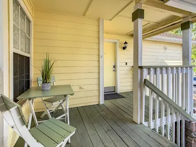 a patio with a table and chairs on a porch at La Casa Mediterranean! 3 Bedroom Condo Near Disney! in Kissimmee
