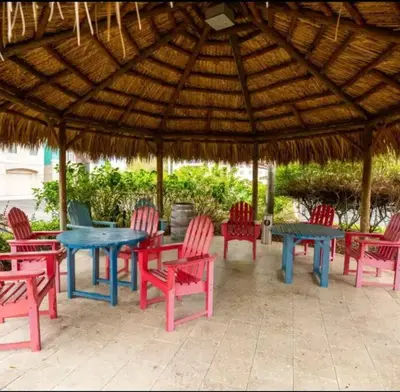 a group of tables and chairs under a wooden umbrella at Paradise island near Disney in Kissimmee