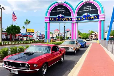 a group of cars parked in front of an old town at Paradise island near Disney in Kissimmee