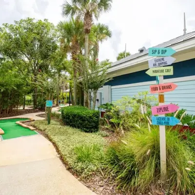 a sign with street signs in front of a house at Paradise island near Disney in Kissimmee
