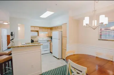 a kitchen with a table and a white refrigerator at Paradise island near Disney in Kissimmee