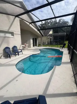 a swimming pool in the middle of a house at Resort Community 4 Bedroom Family Home, Pool & 15 Min Disney in Kissimmee
