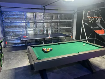 a room with a pool table and ping pong balls at Resort Community 4 Bedroom Family Home, Pool & 15 Min Disney in Kissimmee