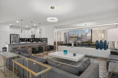 a living room with couches and a kitchen at 2912 Storey Lake new game room 24 guests poolspa in Kissimmee