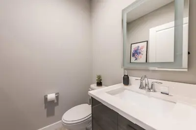 a bathroom with a sink and a toilet and a mirror at Family and Fun Home with Splash Pool at Le Reve 08 in Kissimmee
