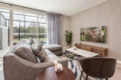 a living room with a couch and chairs and a table at Family and Fun Home with Splash Pool at Le Reve 08 in Kissimmee