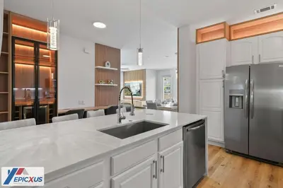 a kitchen with a sink and a stainless steel refrigerator at The Epic Chicago Vista Cay Orlando in Orlando