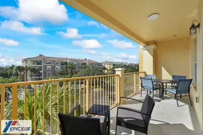 a balcony with chairs and a table with a view at The Epic Chicago Vista Cay Orlando in Orlando