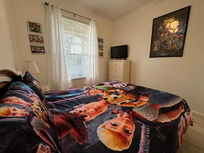 a bedroom with a bed with a movie poster on it at 2778 Windsor Hills 3 Bed Condo- All Included in Orlando