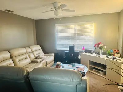 a living room with a couch and a table at Downtown Private Deluxe Room in Orlando