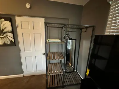 a room with a shelf next to a door at Downtown Private Deluxe Room in Orlando
