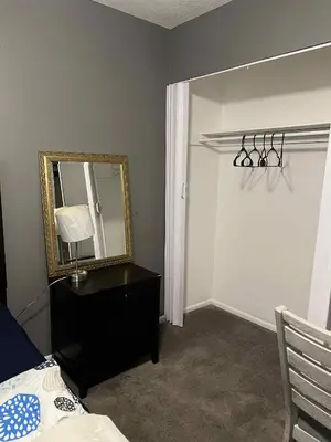 a bedroom with a mirror and a dresser and a bed at Downtown Private Deluxe Room in Orlando