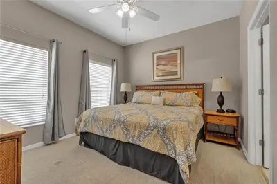a bedroom with a bed and a ceiling fan at Enjoy my cozy house next to Disney in Kissimmee