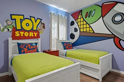 a bedroom with two beds and a toy story mural at Casa Luxo 4Q c/ Piscina e Game Room Avengers in Orlando