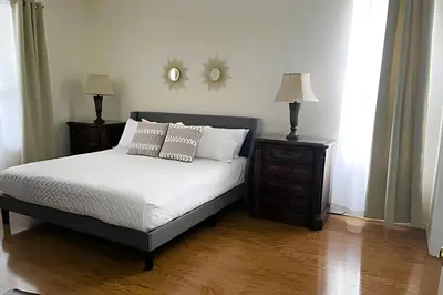 a bedroom with a bed with two night stands and two lamps at 6Q/5.5B Luxo Piscina Priv. Disney in Kissimmee