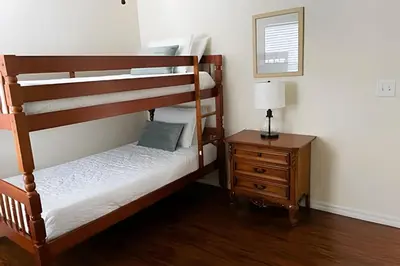 a bedroom with two bunk beds and a night stand at 6Q/5.5B Luxo Piscina Priv. Disney in Kissimmee