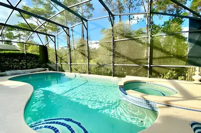 a swimming pool in a house with a glass wall at 6Q/5.5B Luxo Piscina Priv. Disney in Kissimmee