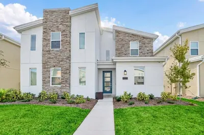 a large white house with a green lawn at Brand New House Private Lake View 3009 Protagonist home in Kissimmee