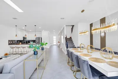 a dining room with long tables and blue chairs at Brand New House Private Lake View 3009 Protagonist home in Kissimmee