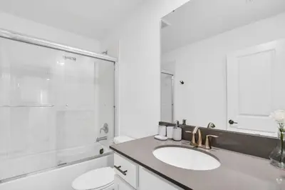 a white bathroom with a sink and a shower at Brand New House Private Lake View 3009 Protagonist home in Kissimmee