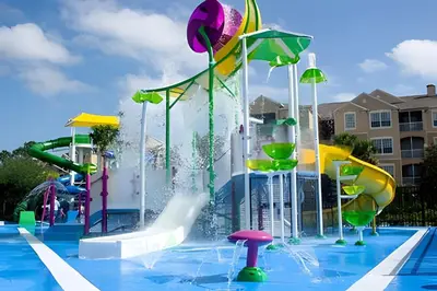 a pool with a water park with a water slide at Familiar 3 Quartos Perto da Disney! in Orlando