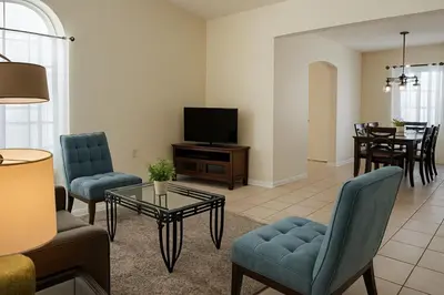 a living room with a couch and a tv at Indian Wells 3Q/2B Perto da Disney in Kissimmee