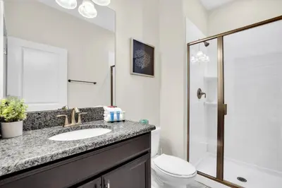 a bathroom with a sink and a toilet and a shower at 4804Crusoe townhouse in Kissimmee