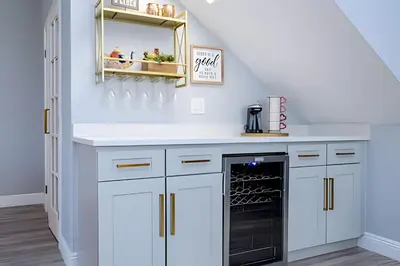 a kitchen with white cabinets and a black dishwasher at 6BD/4BA Windsor Hills | Sala de Jogos & Piscina in Orlando
