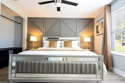 a bedroom with a large bed with a large headboard at 6BD/4BA Windsor Hills | Sala de Jogos & Piscina in Orlando