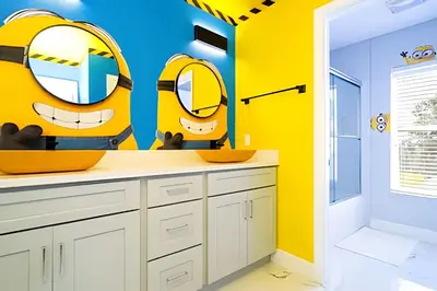 a bathroom with yellow walls and a sink and mirrors at 6BD/4BA Windsor Hills | Sala de Jogos & Piscina in Orlando