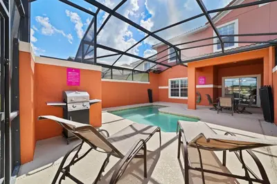 a patio with chairs and a swimming pool at 8929 Candy Palm Road in Kissimmee