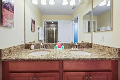 a bathroom with two sinks and a large mirror at 8929 Candy Palm Road in Kissimmee