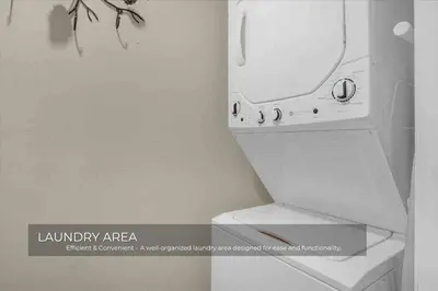 a bathroom with a toilet with a laundry area sign at Mills Lakeside in Orlando