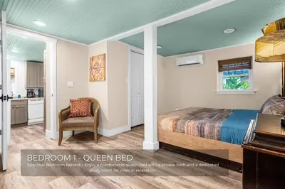 a bedroom with a bed and a chair at Mills Lakeside in Orlando
