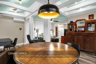a dining area with a wooden table and chairs at Mills Lakeside in Orlando